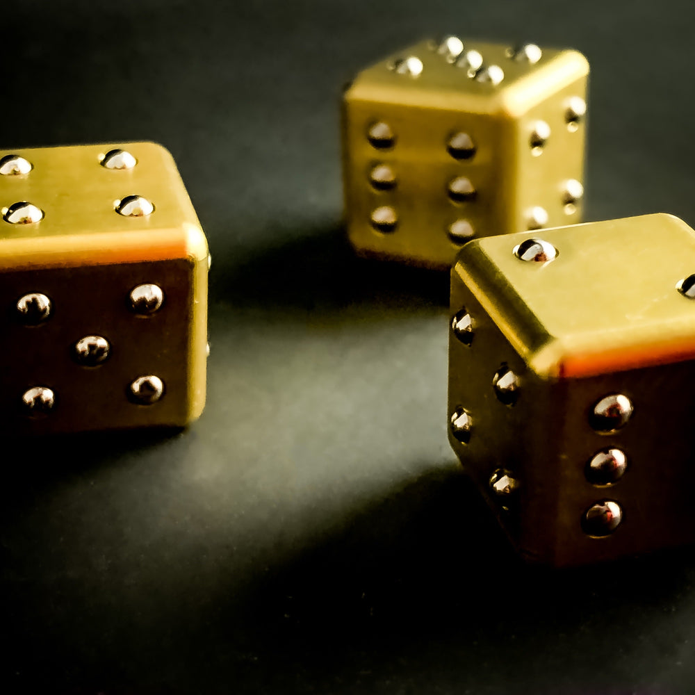 Solid_brass_dice_with_raised_pip_ball_bearing