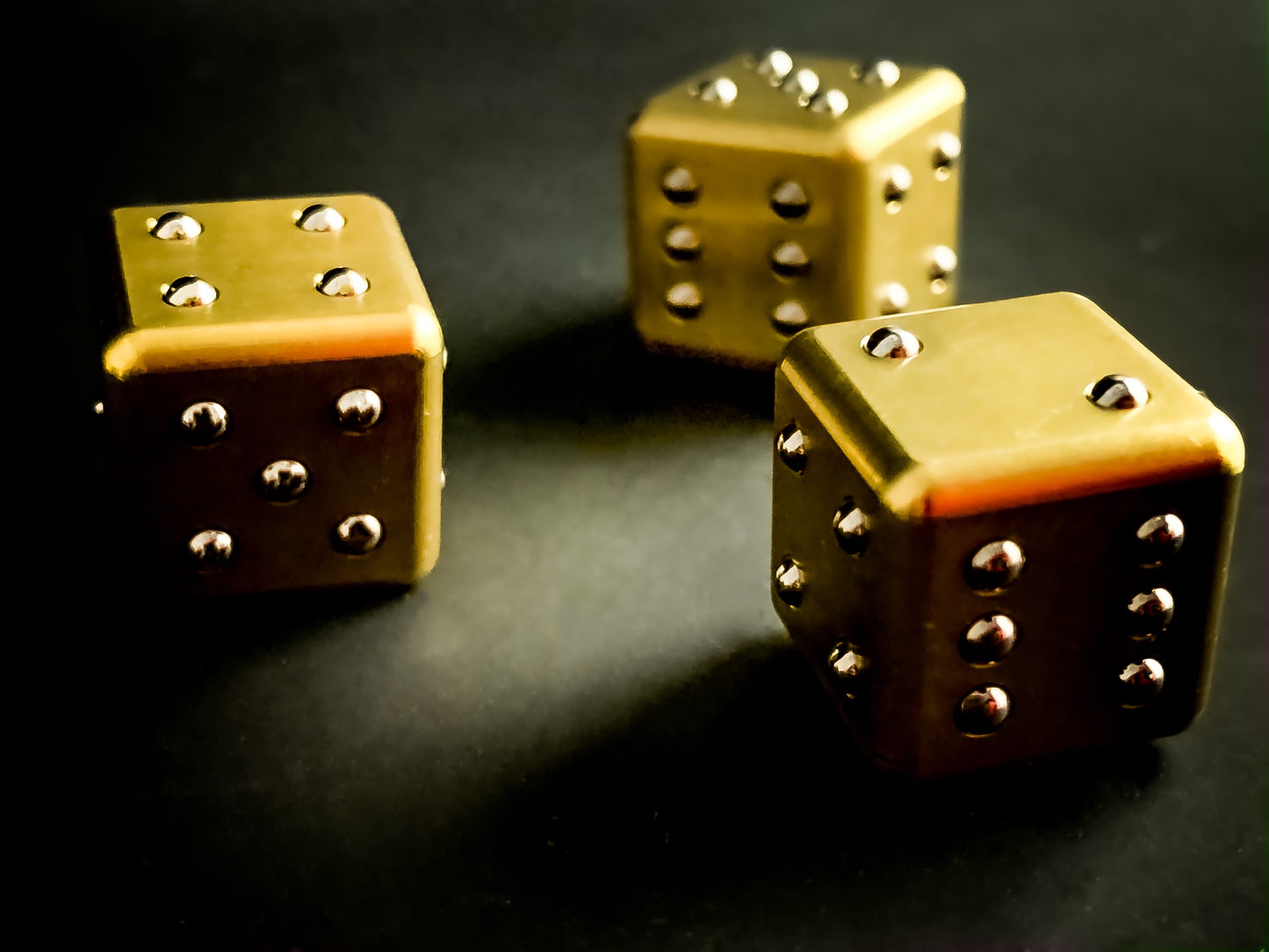 Solid_brass_dice_with_raised_pip_ball_bearing