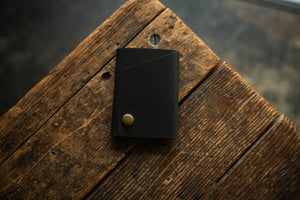 Handmade minimal leather Rollout Wallet has a single pocket for cards, and nicely rolls your cash and secures with a snap