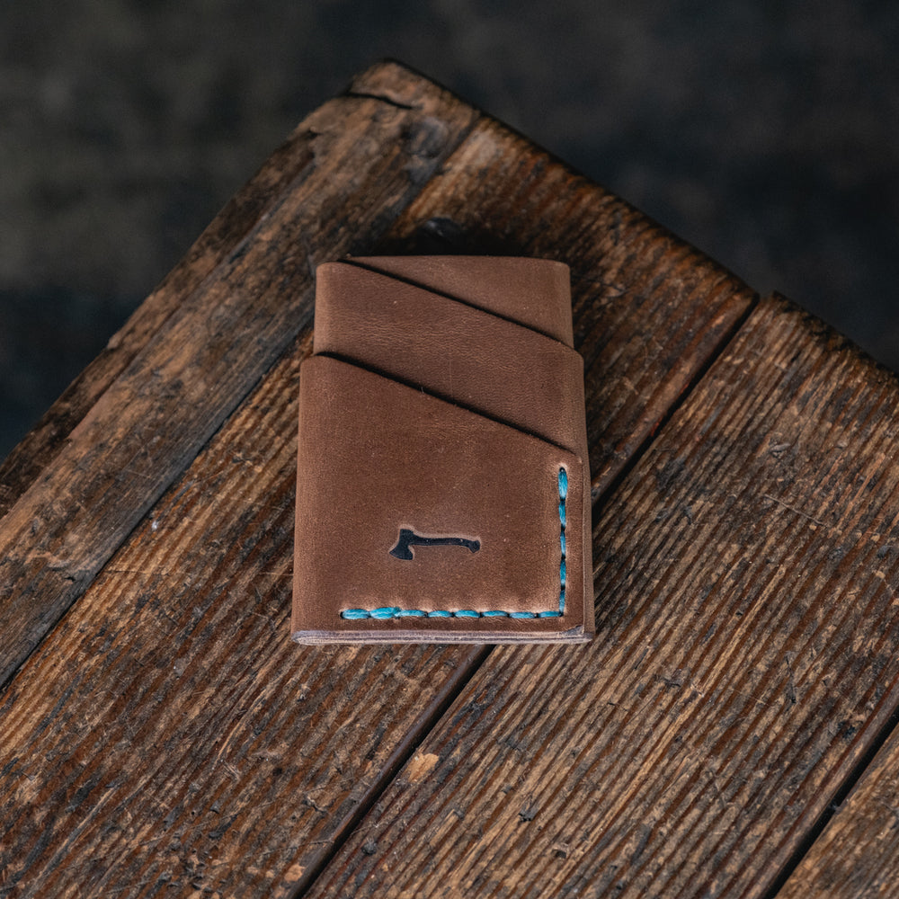 
                  
                    Port Wallet, Horween Chromexcel Natural hand stitched with turquoise blue thread
                  
                