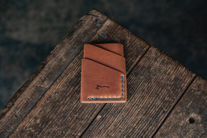 
            
                Load image into Gallery viewer, Port Wallet Craft and Lore, Horween Dublin English Tan and hand stitched with turquoise blue thread
            
        